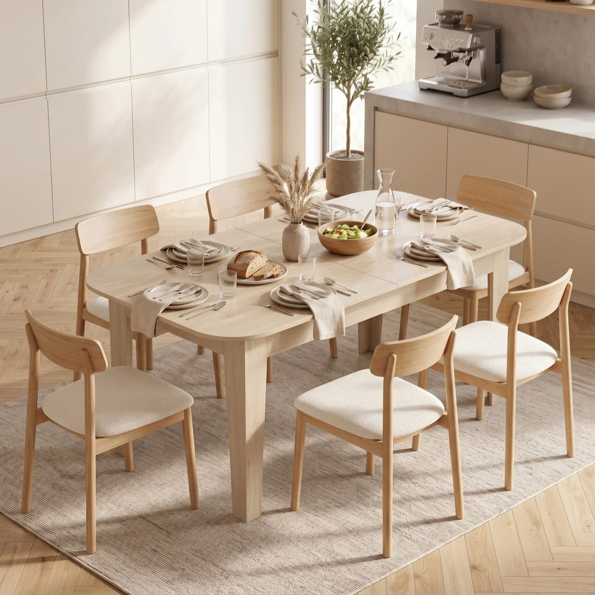 Light oak extendable oval dining table with four chairs and table centerpiece
