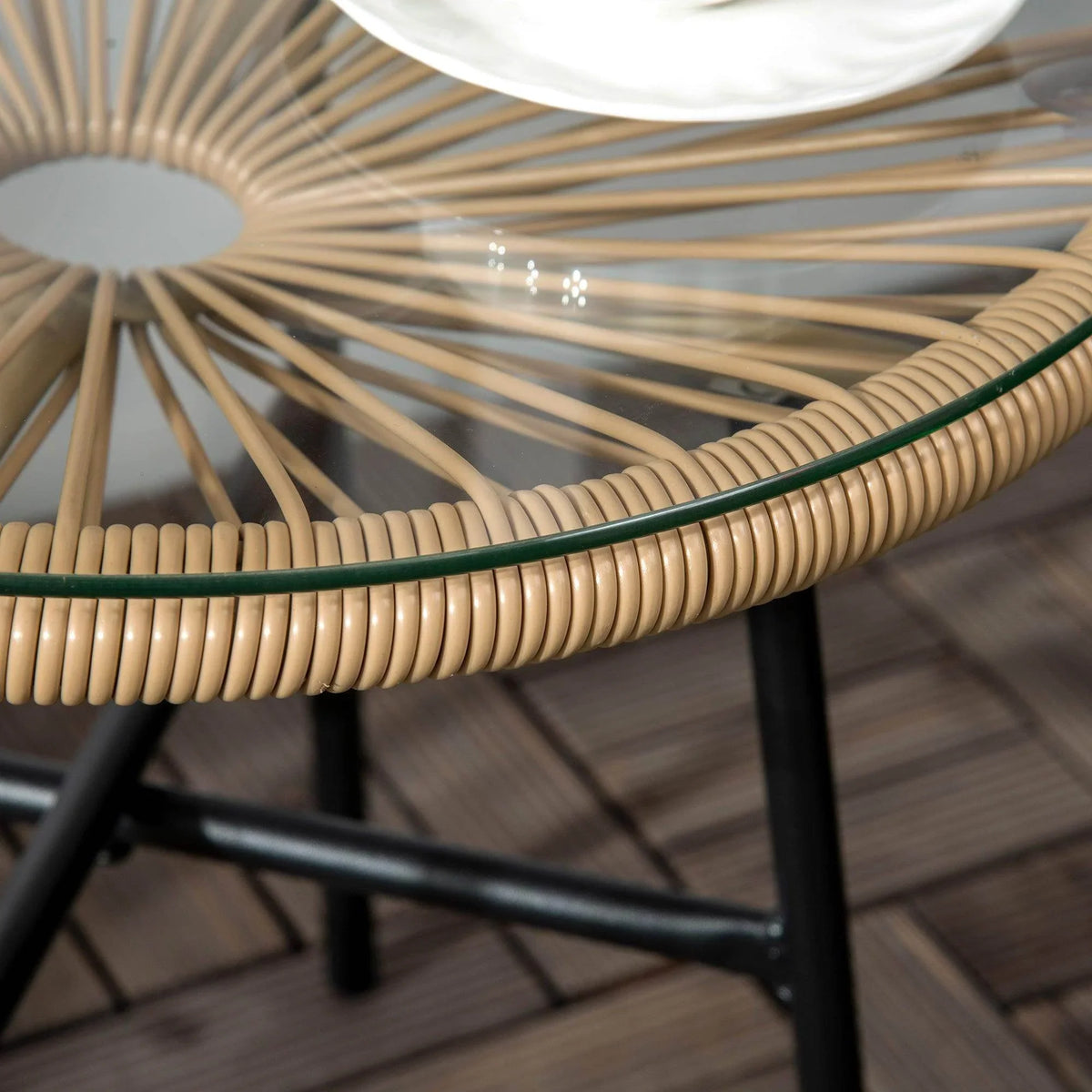 Close-up of round rattan tabletop rim with black metal base