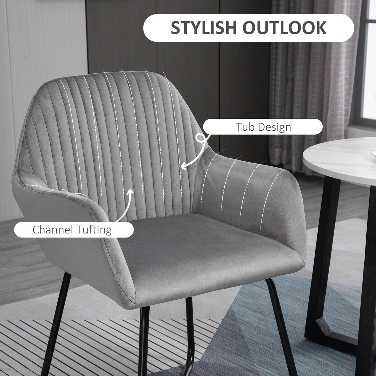 Grey velvet-look accent chair with vertical channel tufting, curved tub-style back and arms