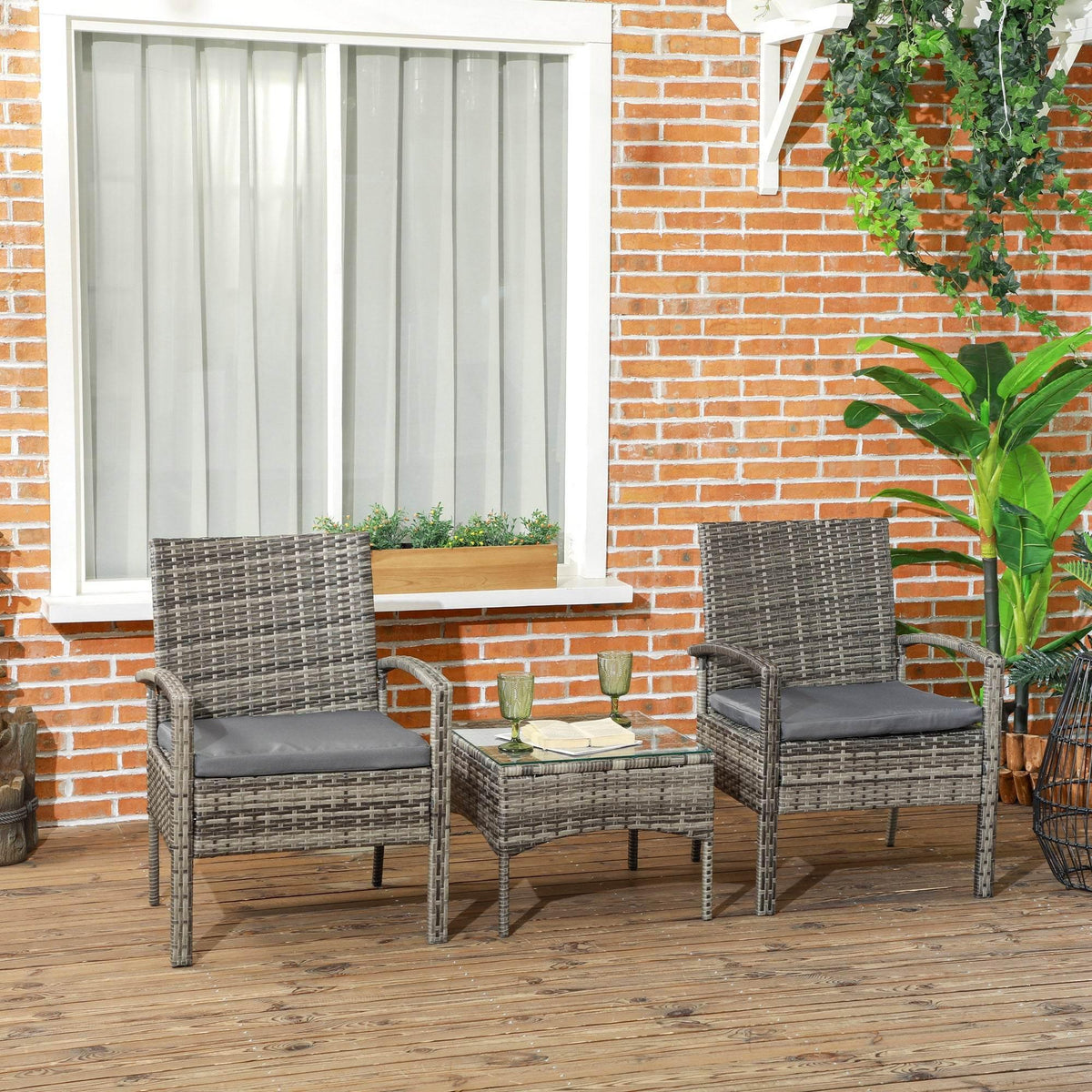 Grey rattan bistro set with two cushioned chairs and square coffee table