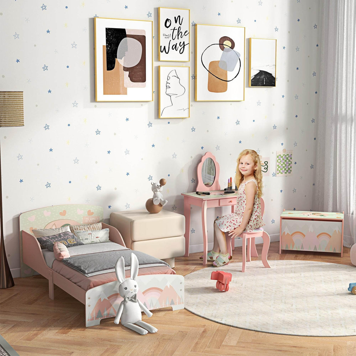 Kids bedroom furniture set in pink: low bed, vanity table, and toy chest.