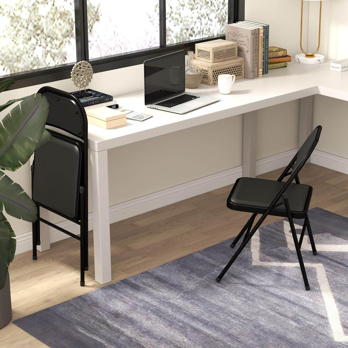 Folding chair with black PU leather padded seat and back, folding steel frame