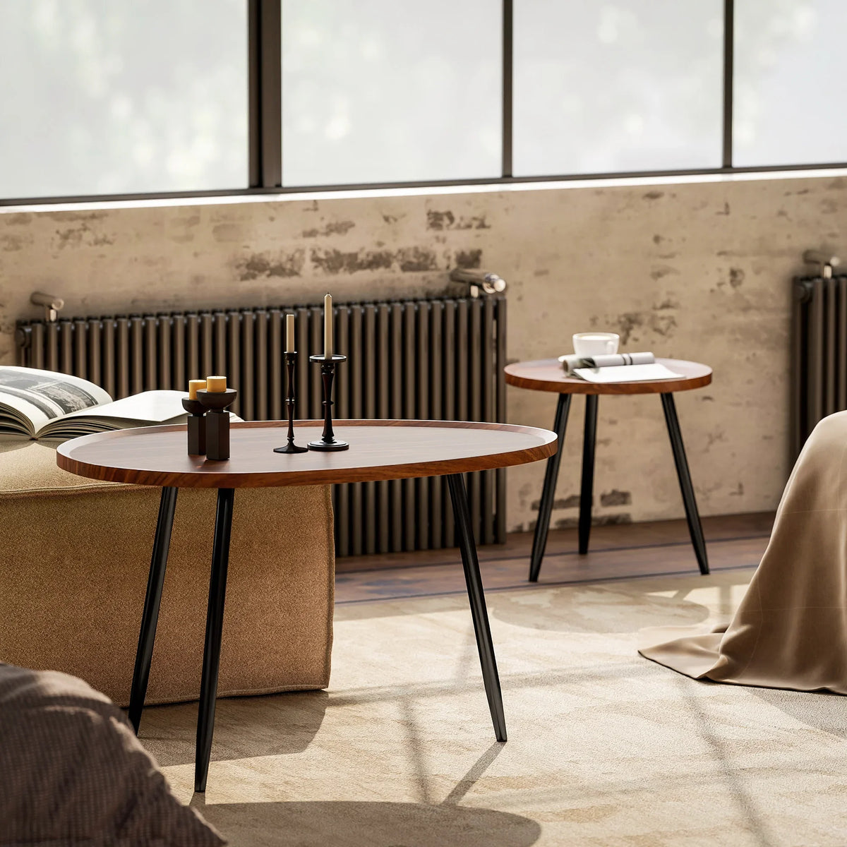 Two round nesting tables with chestnut wood-effect tops and black metal legs indoors