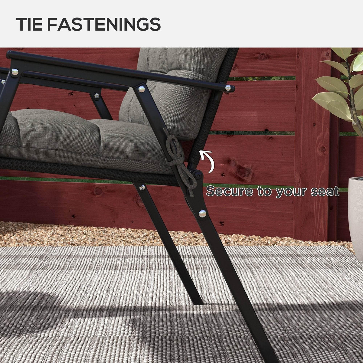 Charcoal grey chair cushion with tie fastenings securing the seat and backrest