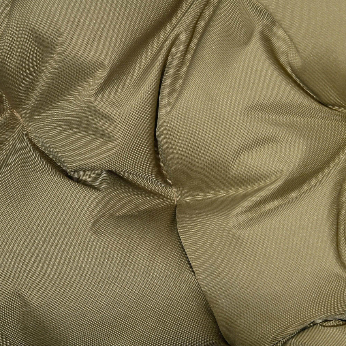 Close-up of khaki padded cushion with quilted tufted fabric texture