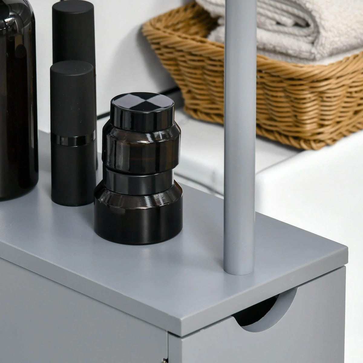 Grey cabinet top shelf with small black toiletry containers and bottles