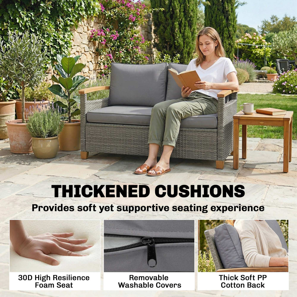 Dark grey rattan outdoor sofa with thick cushions and acacia wood armrests