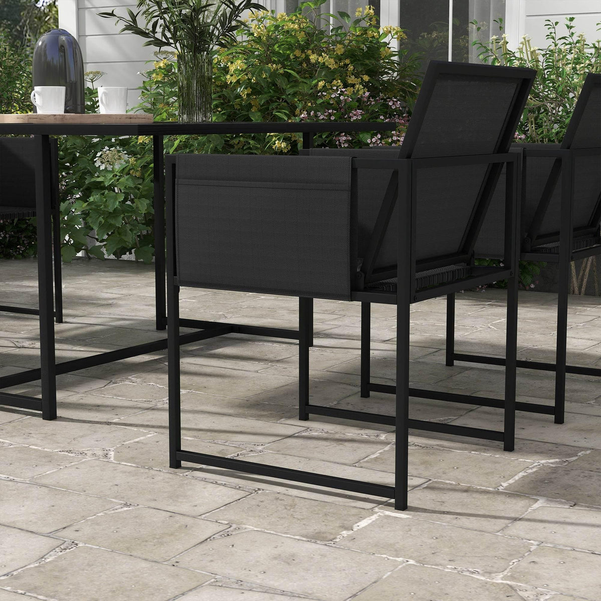 Black mesh dining chair with slatted back and armrests, patio set