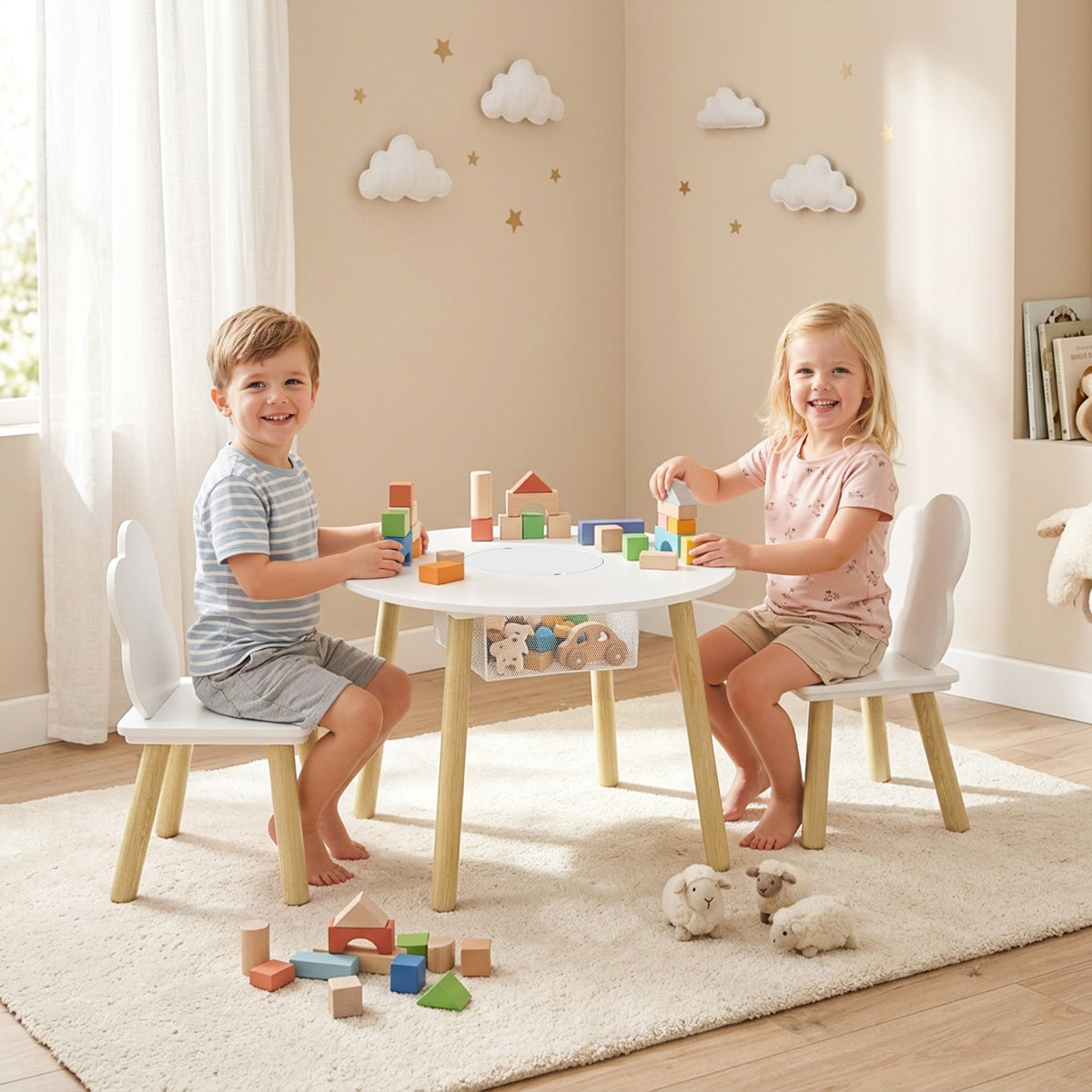 White kids table with two chairs and under-table storage net, with children playing