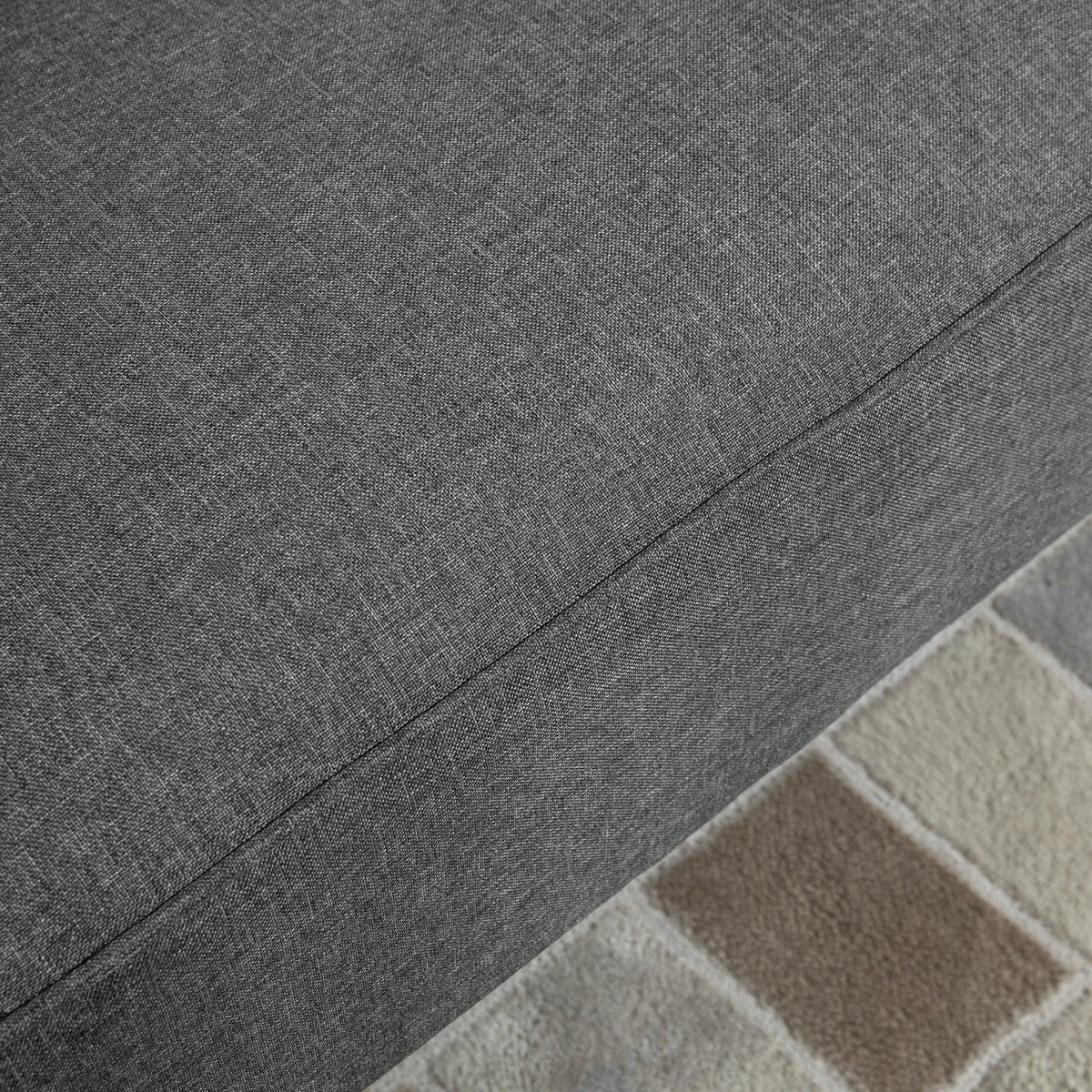 Close-up of dark grey woven fabric upholstery with subtle texture