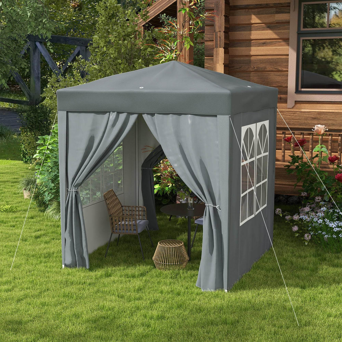 Grey pop-up gazebo with curtained entrance and side walls featuring arched window panels
