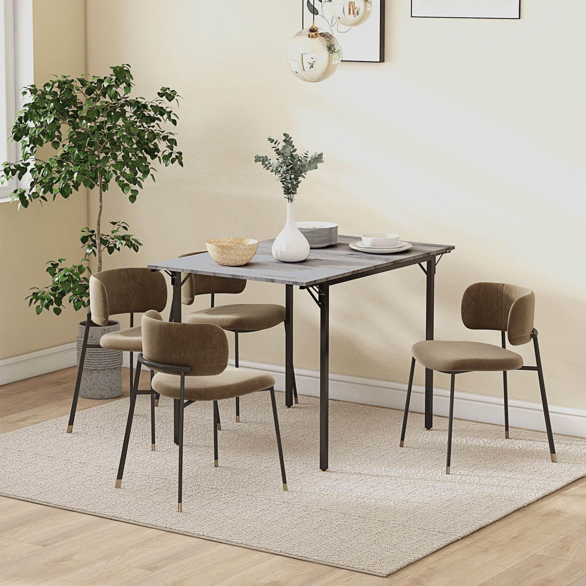 Grey drop-leaf folding dining table with black legs and four matching chairs