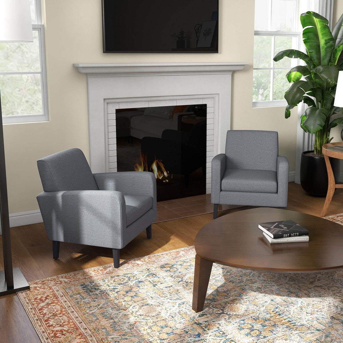 Grey upholstered armchairs with dark legs, modern square arms and cushioned seats