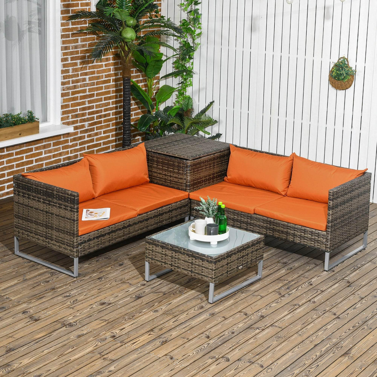 Outdoor wicker patio furniture set with orange seat cushions and storage ottoman