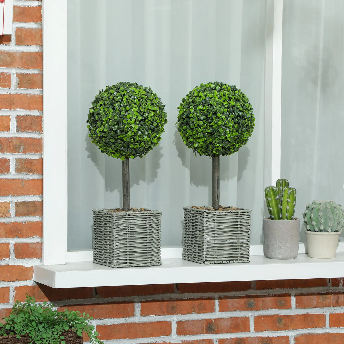 Set of 2 artificial topiary ball plants with green foliage on woven gray plastic pots