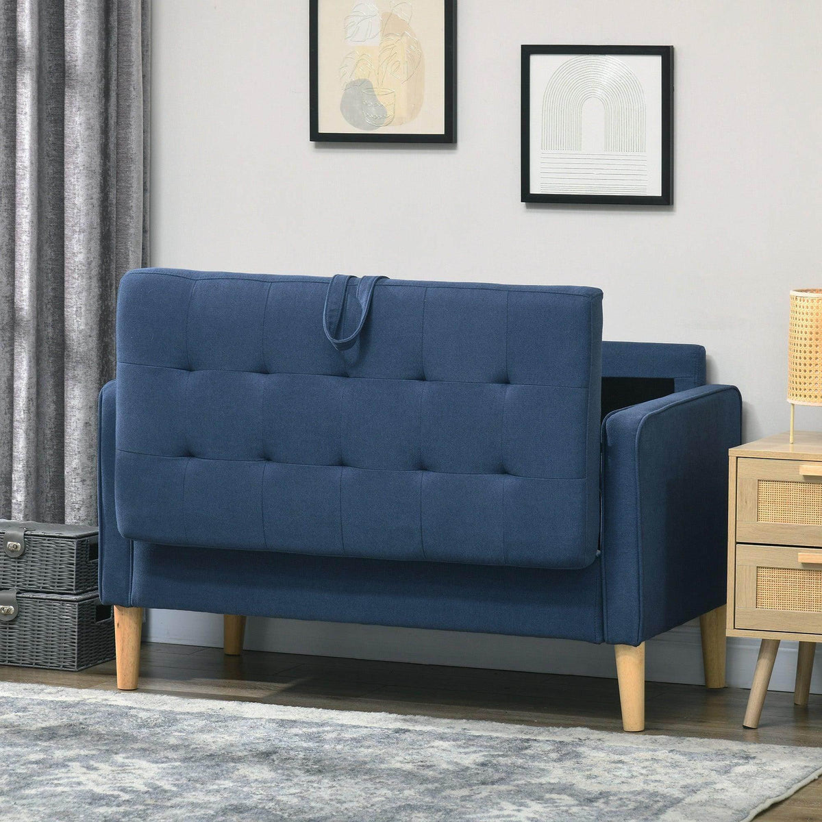 Blue loveseat sofa with button-tufted backrest and armrests, side view
