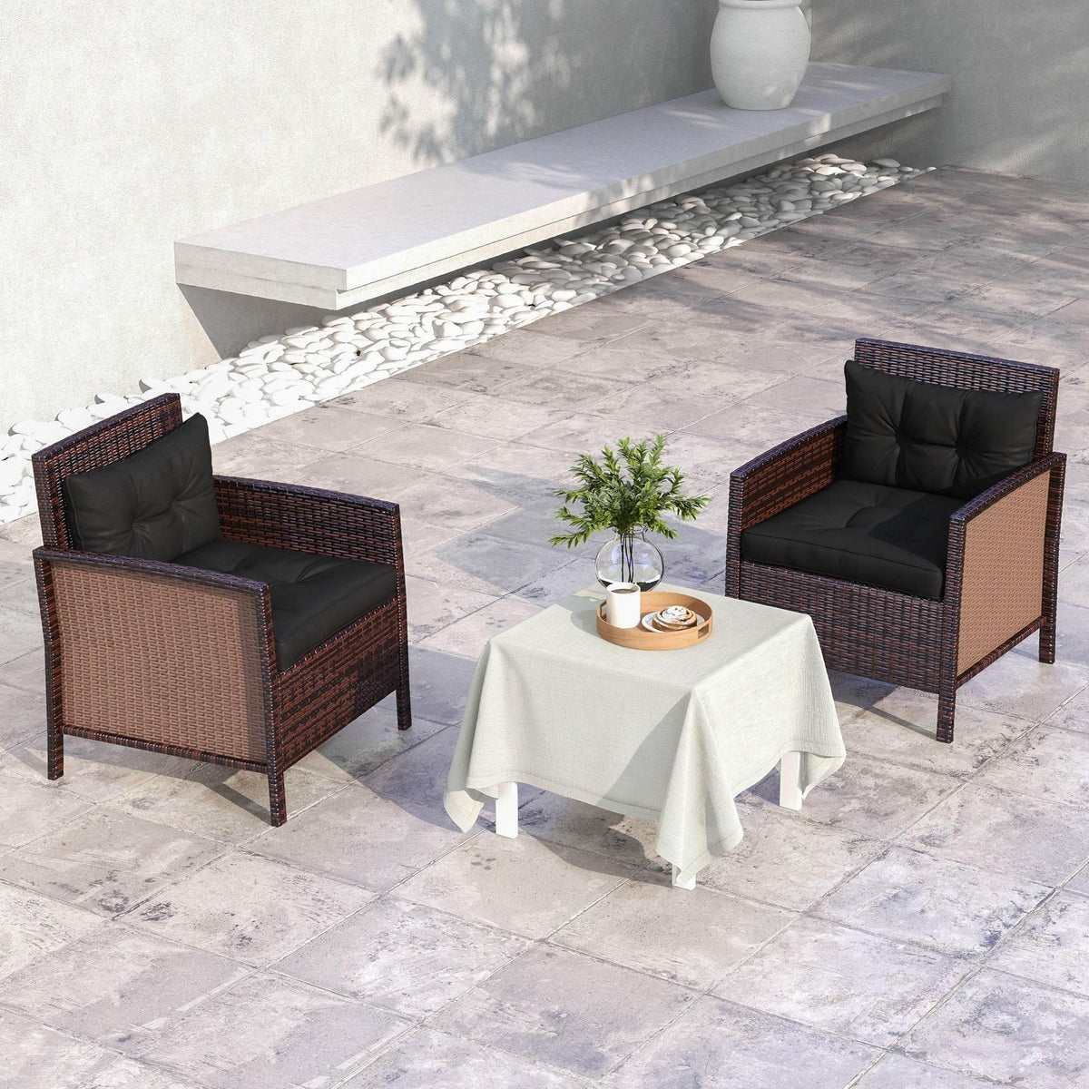 Outdoor patio chairs with black padded seat and back cushions, shown as a set