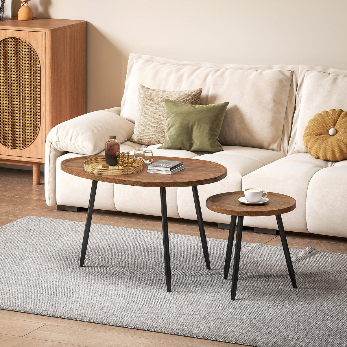 Round nesting coffee tables with chestnut wood-effect tops and black metal legs on rug