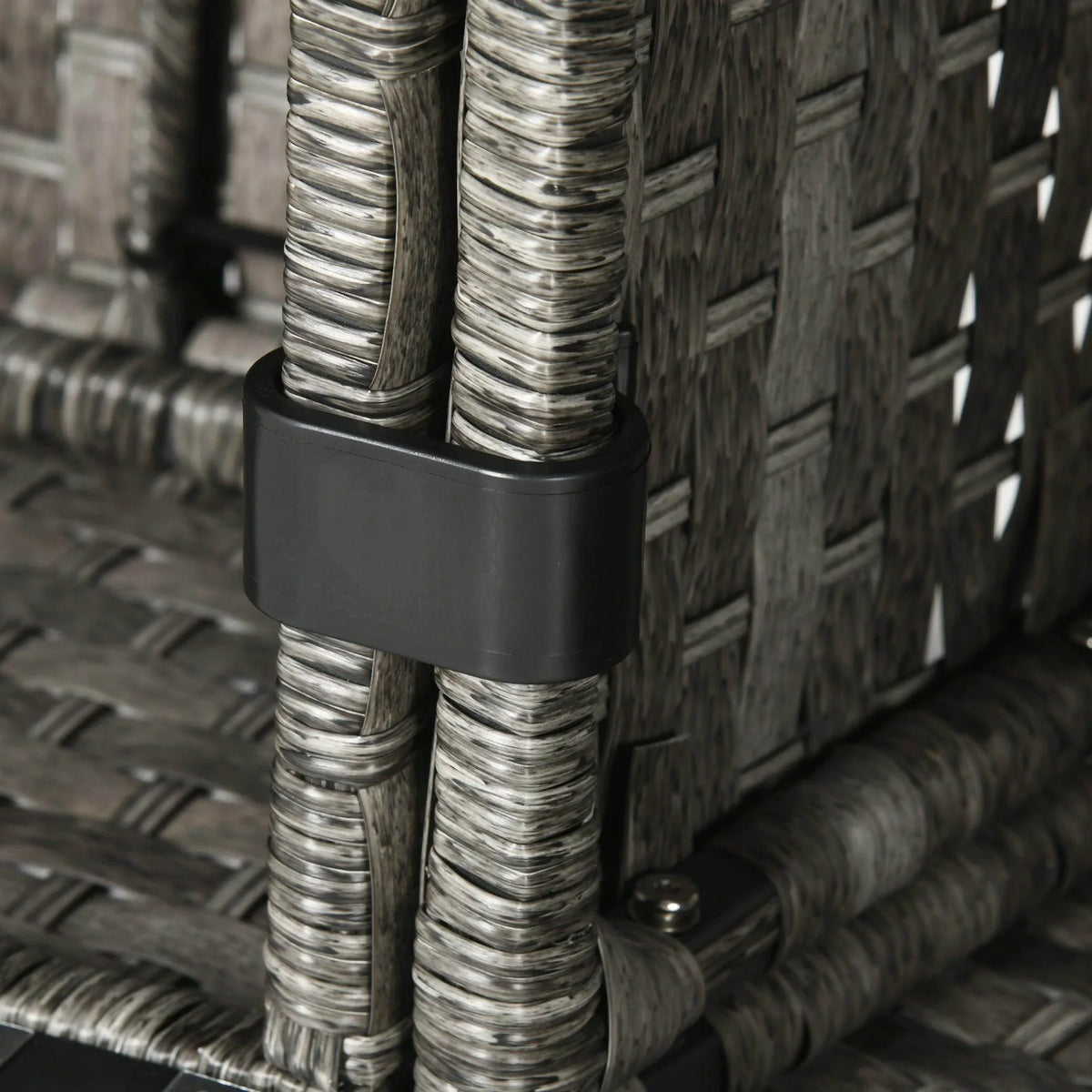 Close-up of gray rattan corner post with dark plastic foot and woven sides