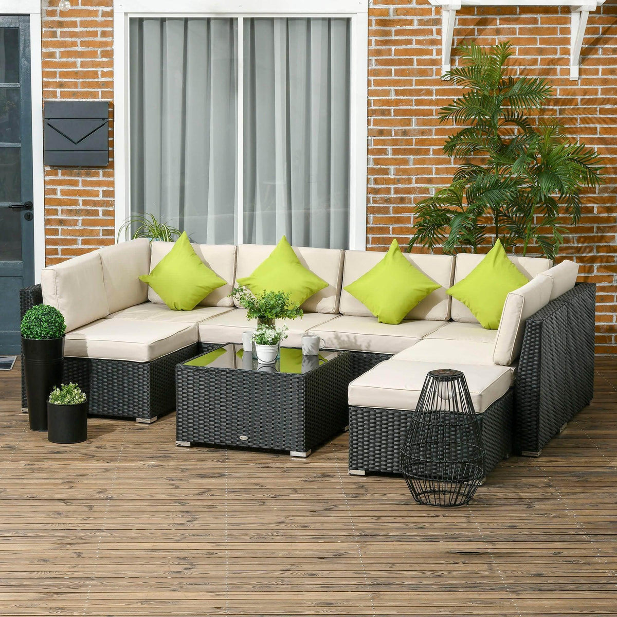 Black outdoor rattan sofa set with cream cushions and bright green throw pillows