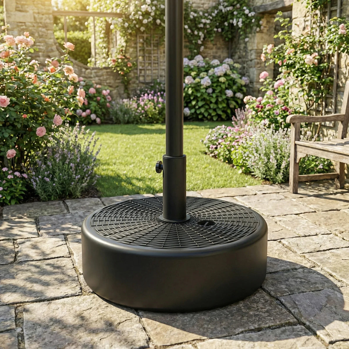 Black circular patio umbrella base with center pole and textured disc top
