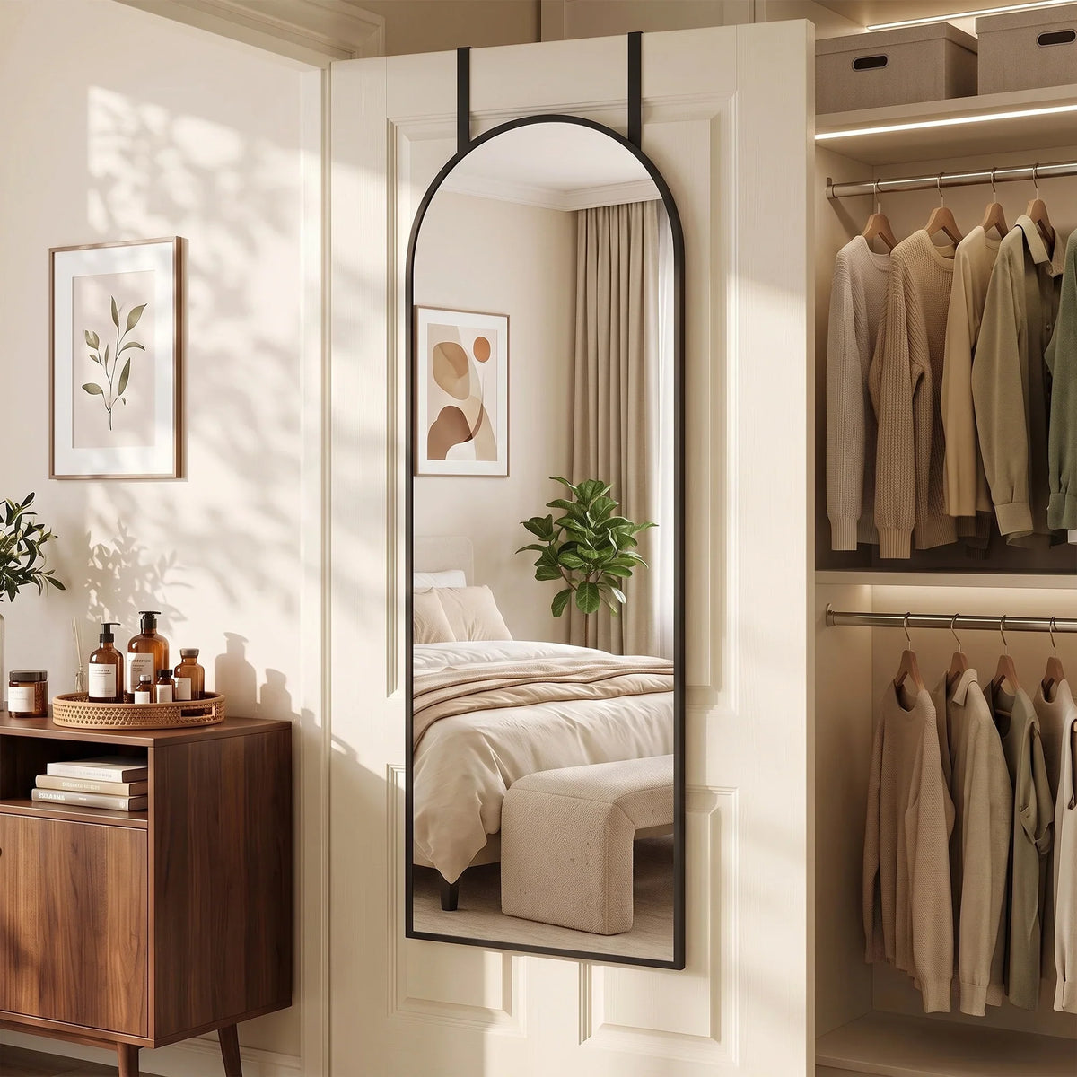 Arched full-length wall mirror with black frame mounted on an interior door