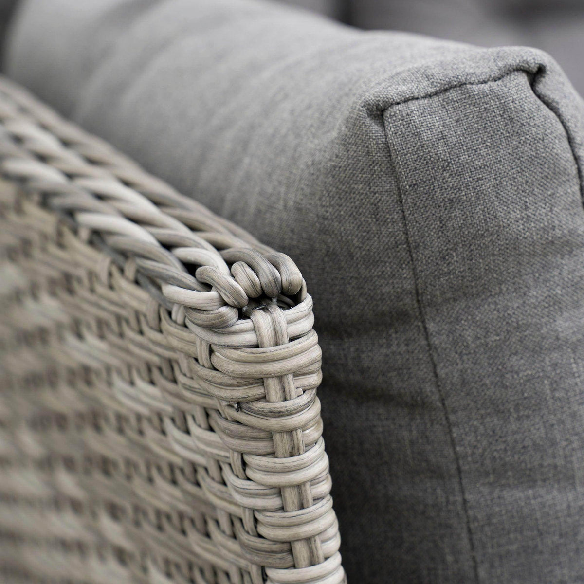 Gray cushioned sectional arm with braided rattan edge detail