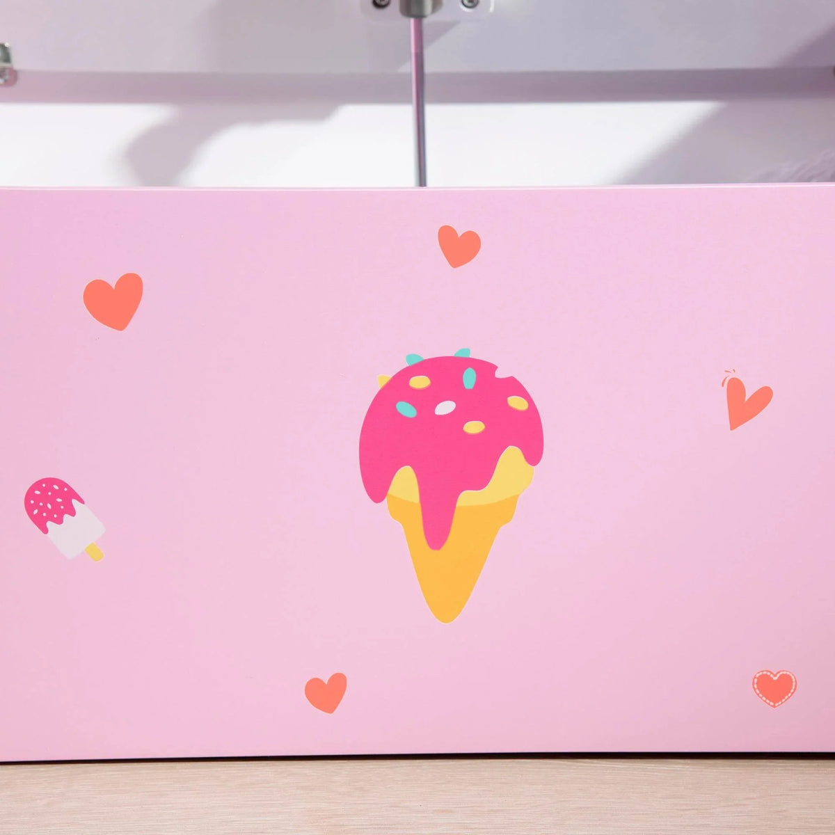 Pink toy storage bench front panel with colorful ice-cream graphic and small hearts