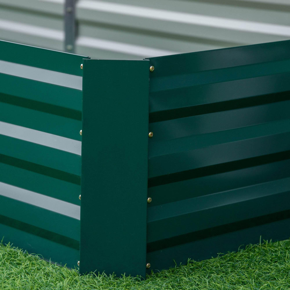 Green galvanized steel raised garden bed corner panel with brass-colored screws