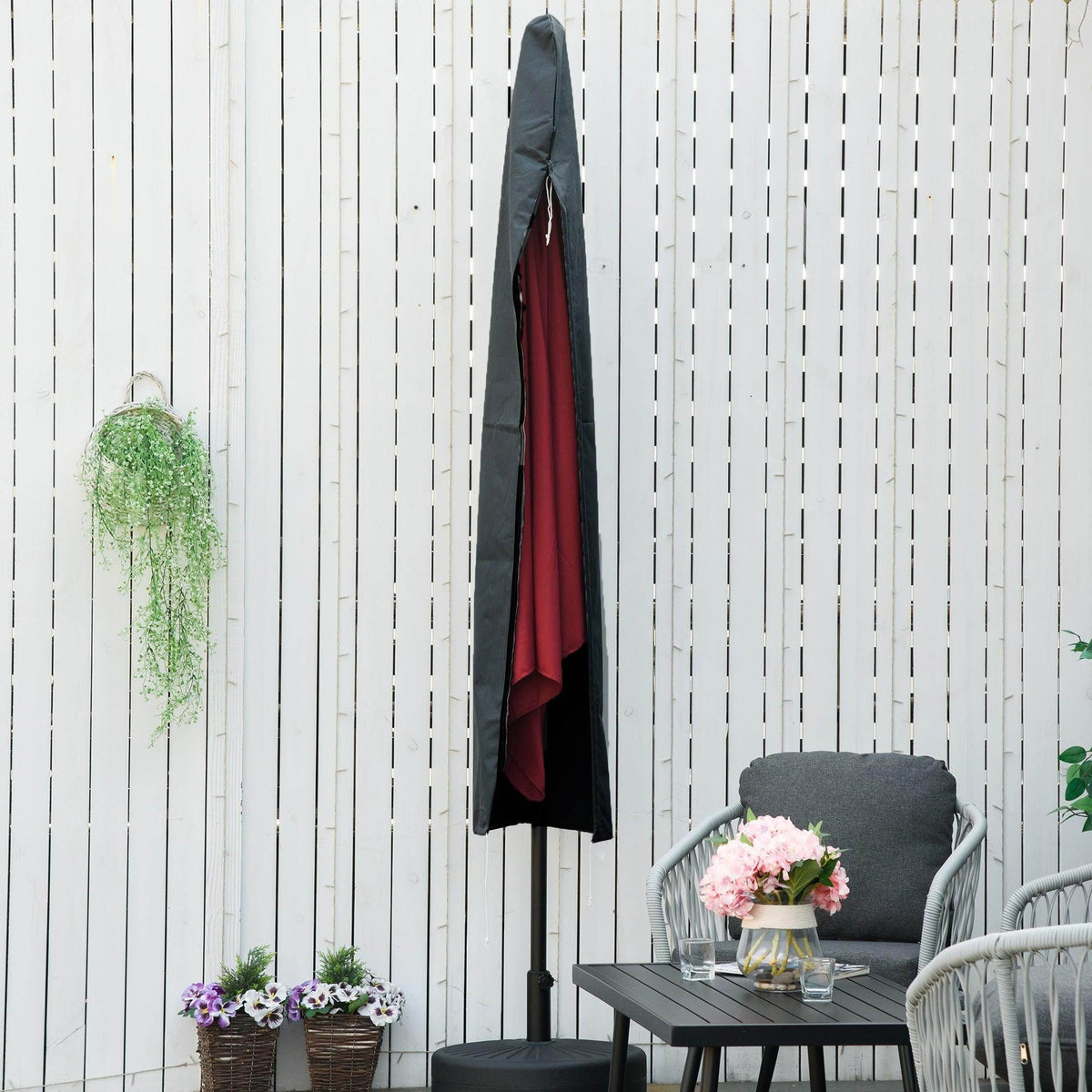 Grey cantilever umbrella cover with red underside panel hanging outdoors