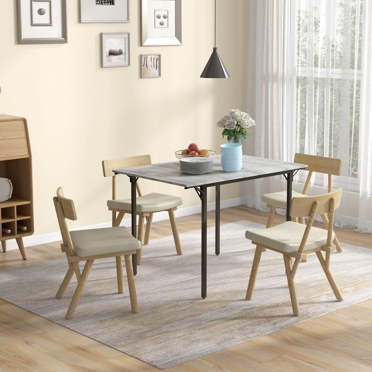 Grey drop-leaf folding dining table with black metal legs, open for 2–4