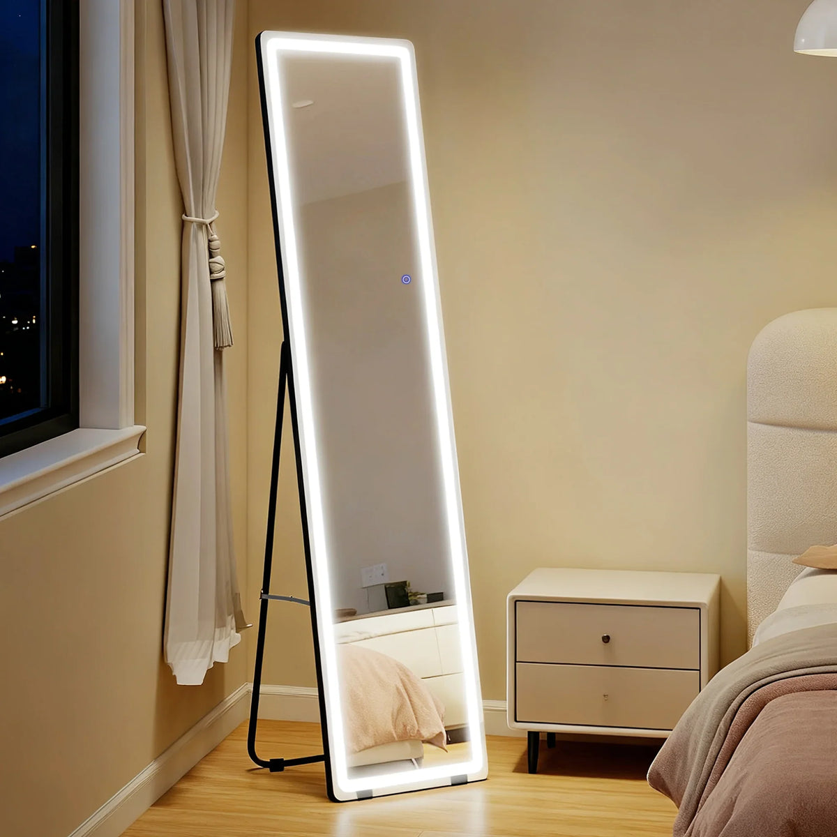Full-length LED mirror with white light border and black frame, freestanding.