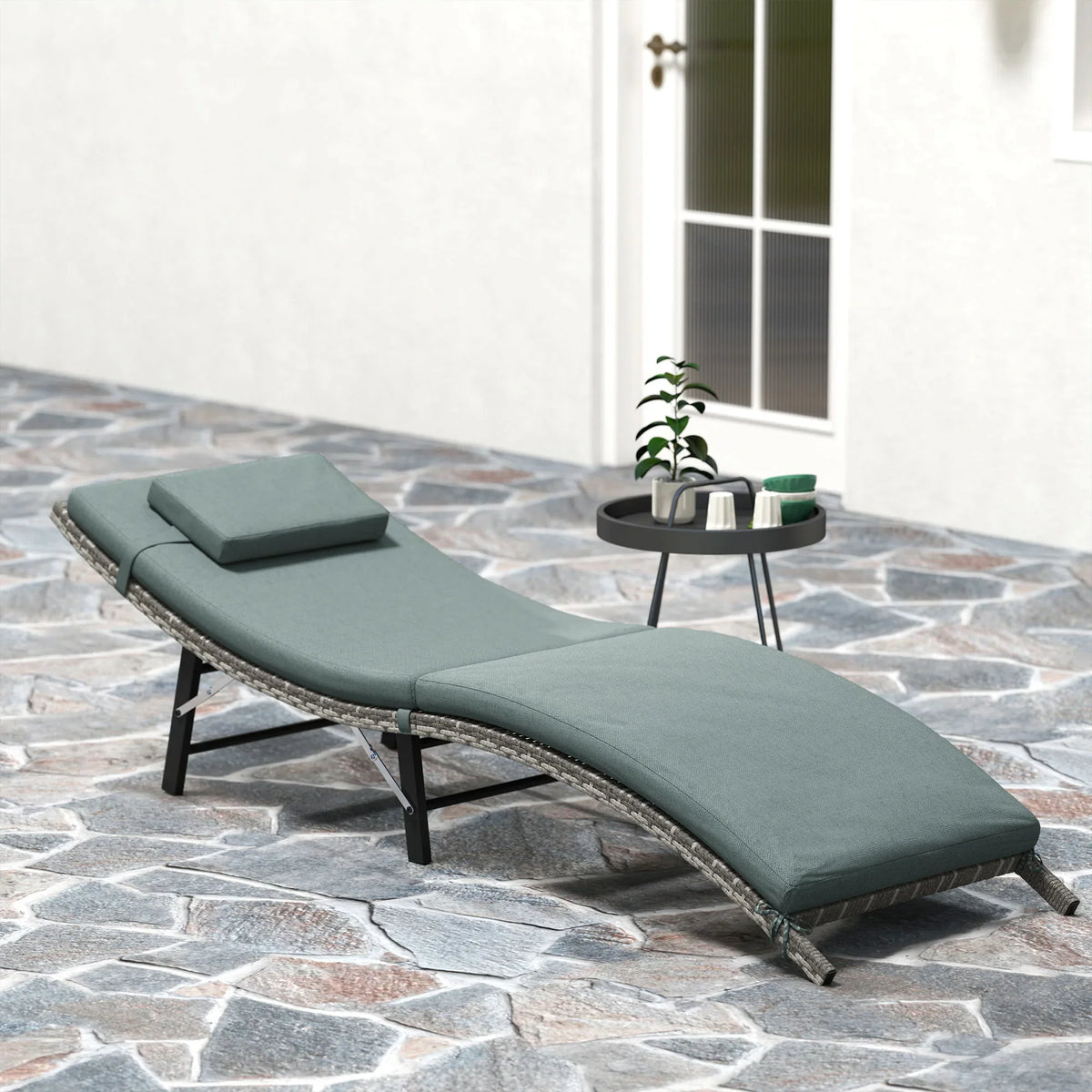 Folding rattan sun lounger with teal cushions and pillow, black folding legs