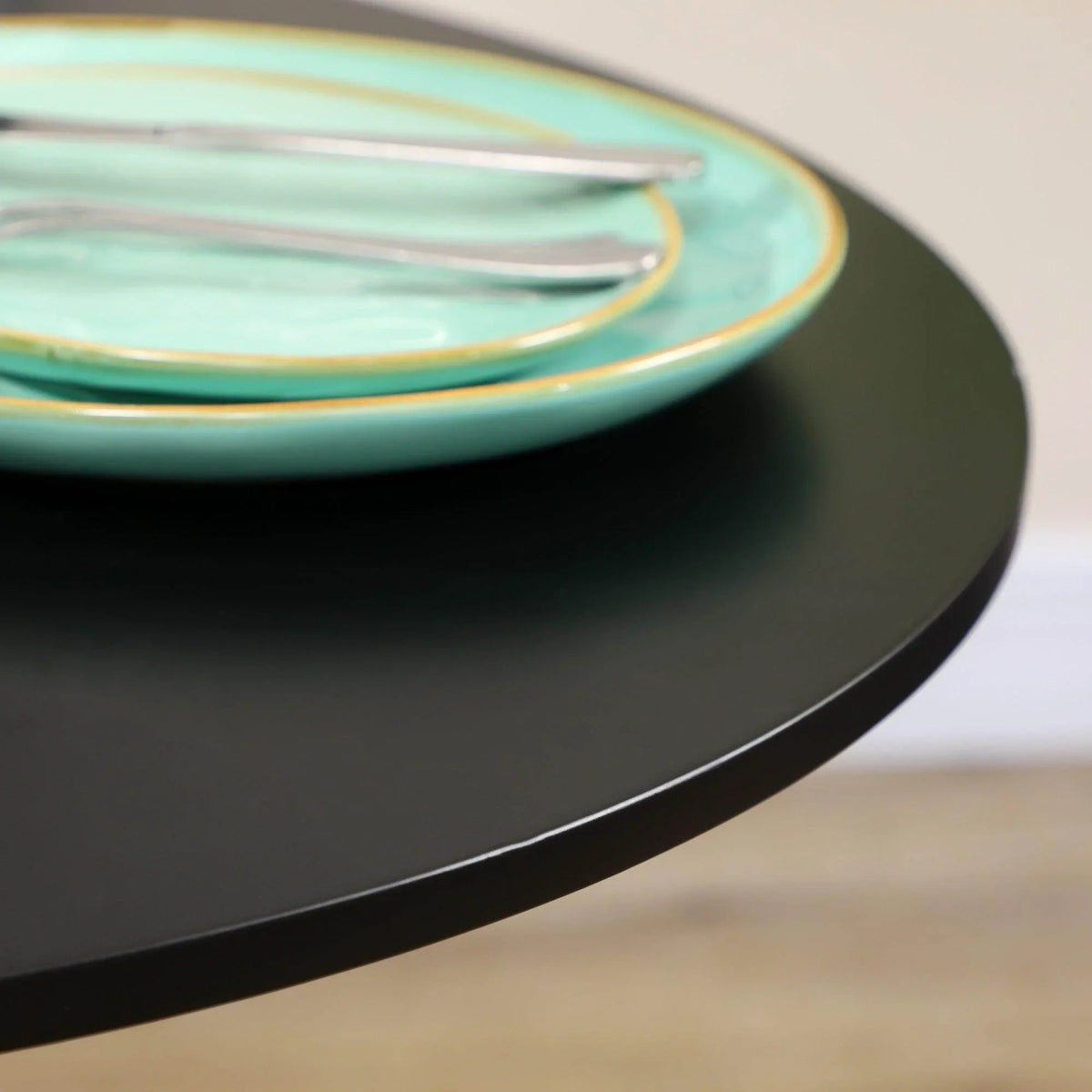 Black round tabletop with a smooth, rounded edge