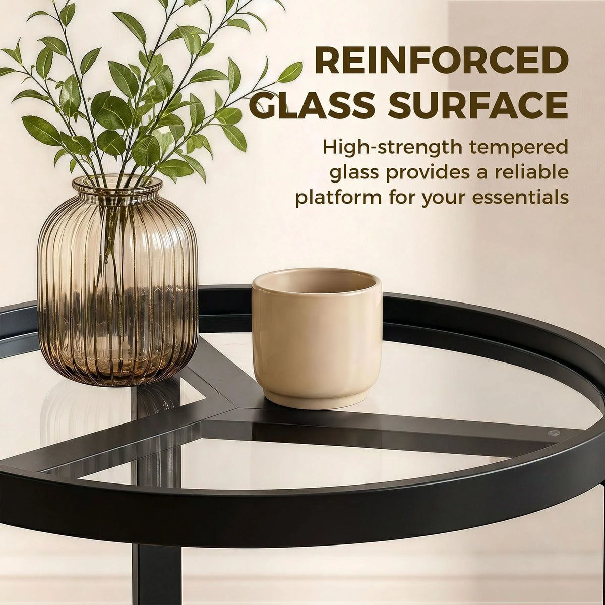 Black round side table with clear tempered glass surface and geometric metal frame