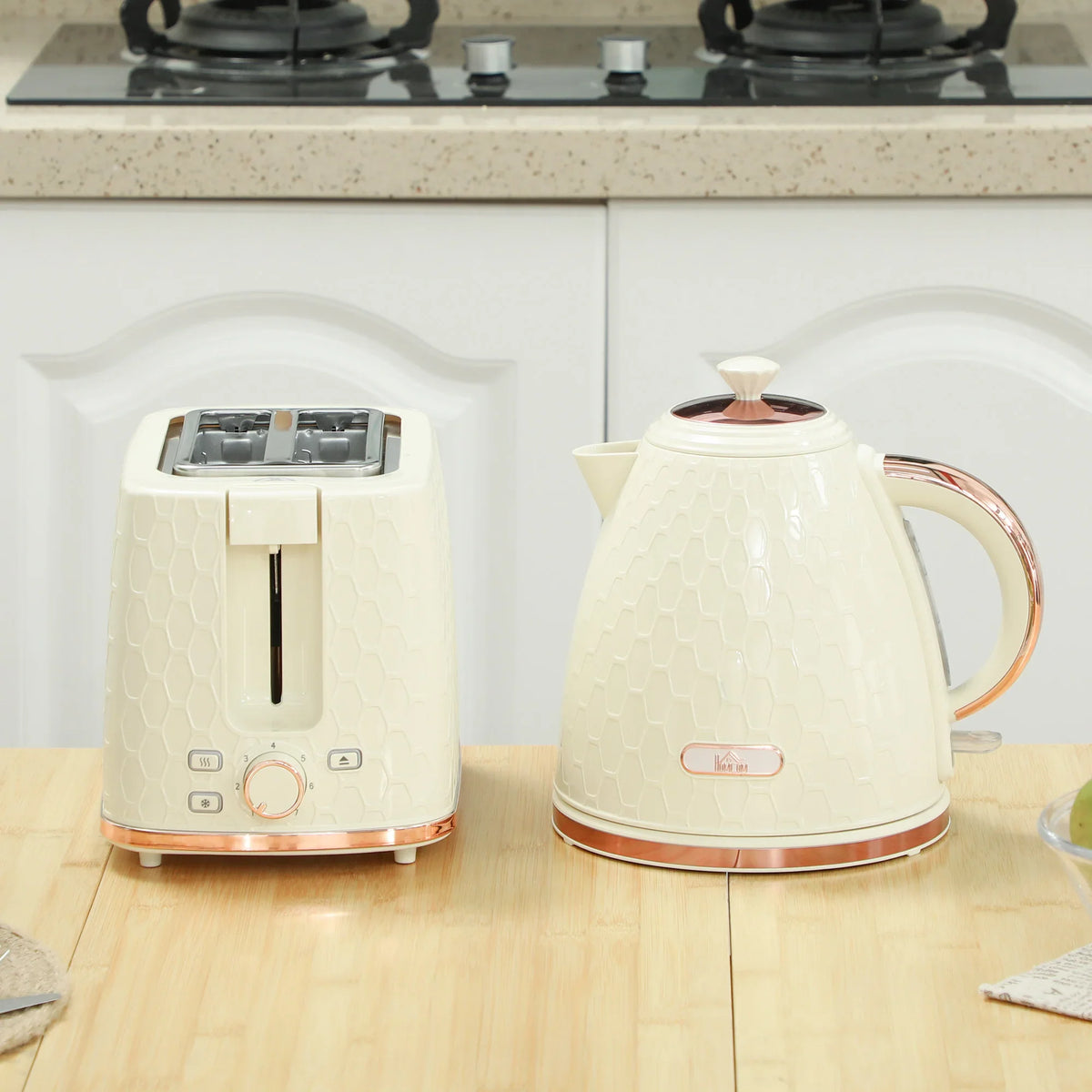 Beige electric kettle and 2-slice toaster set on kitchen countertop.