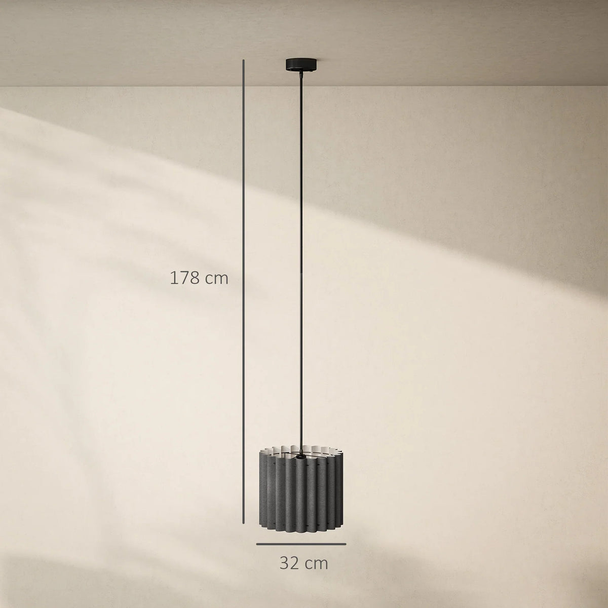 Black pendant light with cylindrical ribbed shade, hanging cord, and round ceiling mount