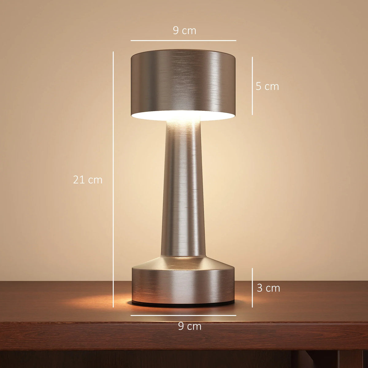 Silver cordless table lamp with cylindrical shade and round base, glowing