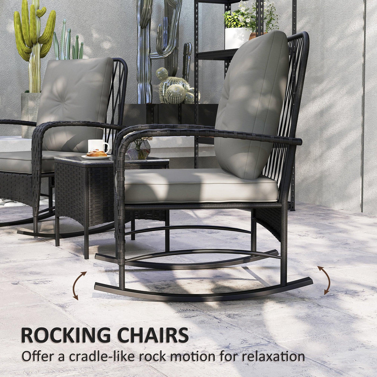 Two black rattan rocking chairs with gray cushions and a glass-top table