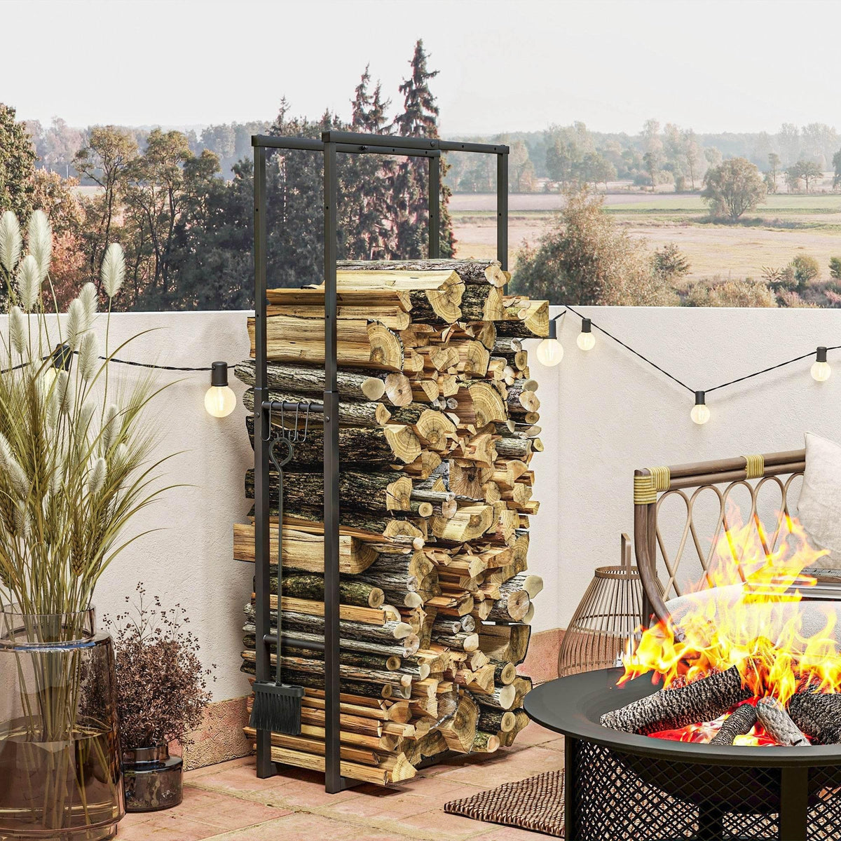 Black metal firewood log rack with hooks holding stacked cut logs indoors/outdoors