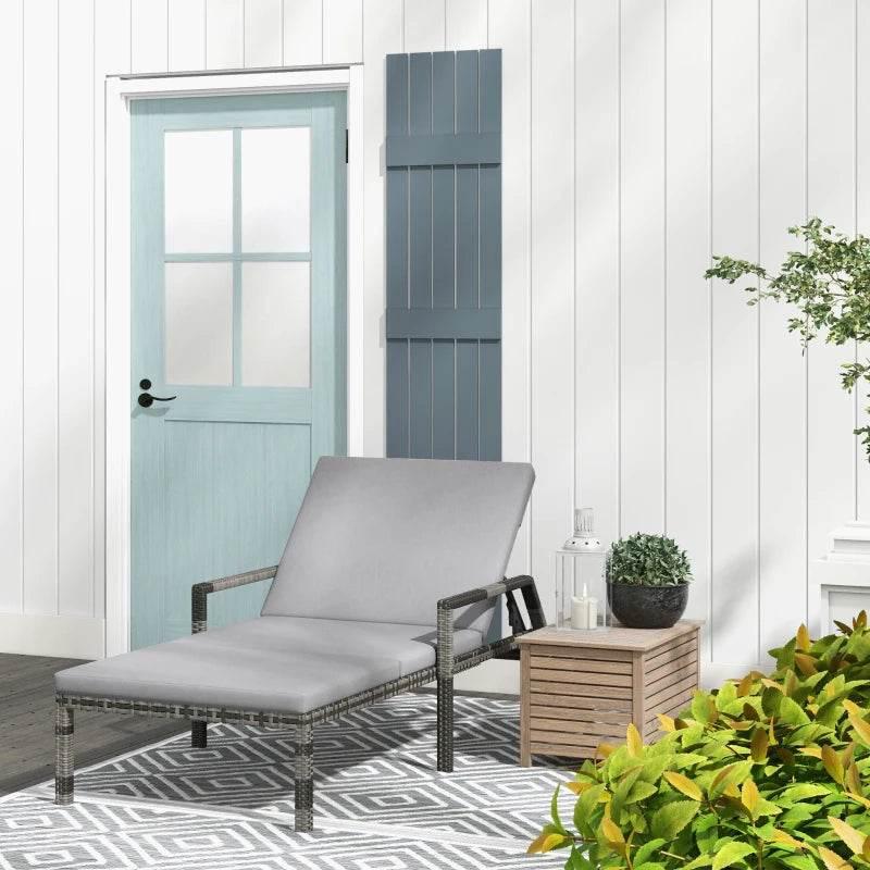 Outdoor rattan sun lounger with gray padded cushion and reclined backrest