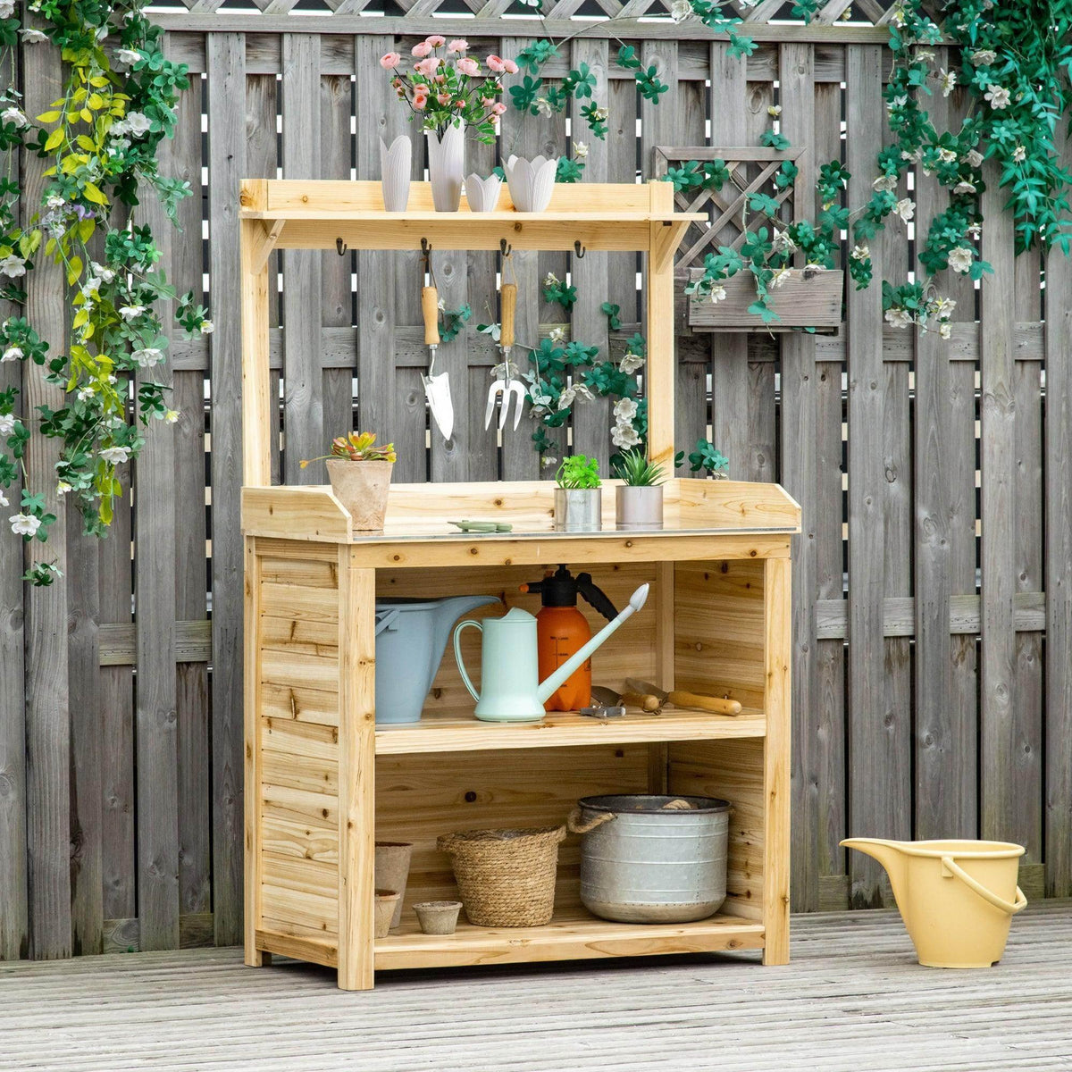 Wooden potting bench with galvanized tabletop, open shelves, and side hooks