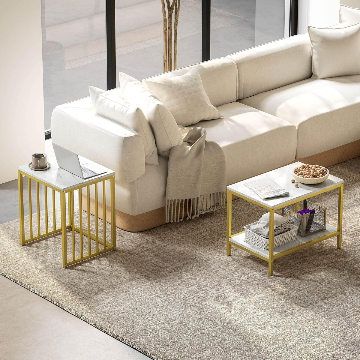 Two nesting coffee tables with faux marble tops and gold steel frames, next to sofa
