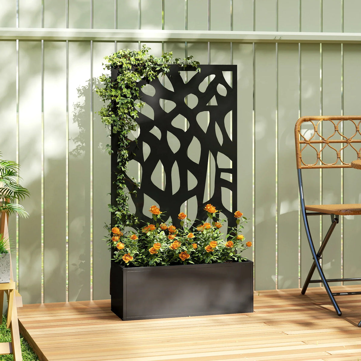 Black metal raised garden bed with trellis panel framed by climbing greenery