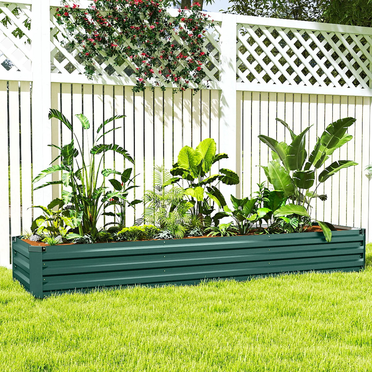 Dark green raised garden bed planter with tall leafy plants along the full length