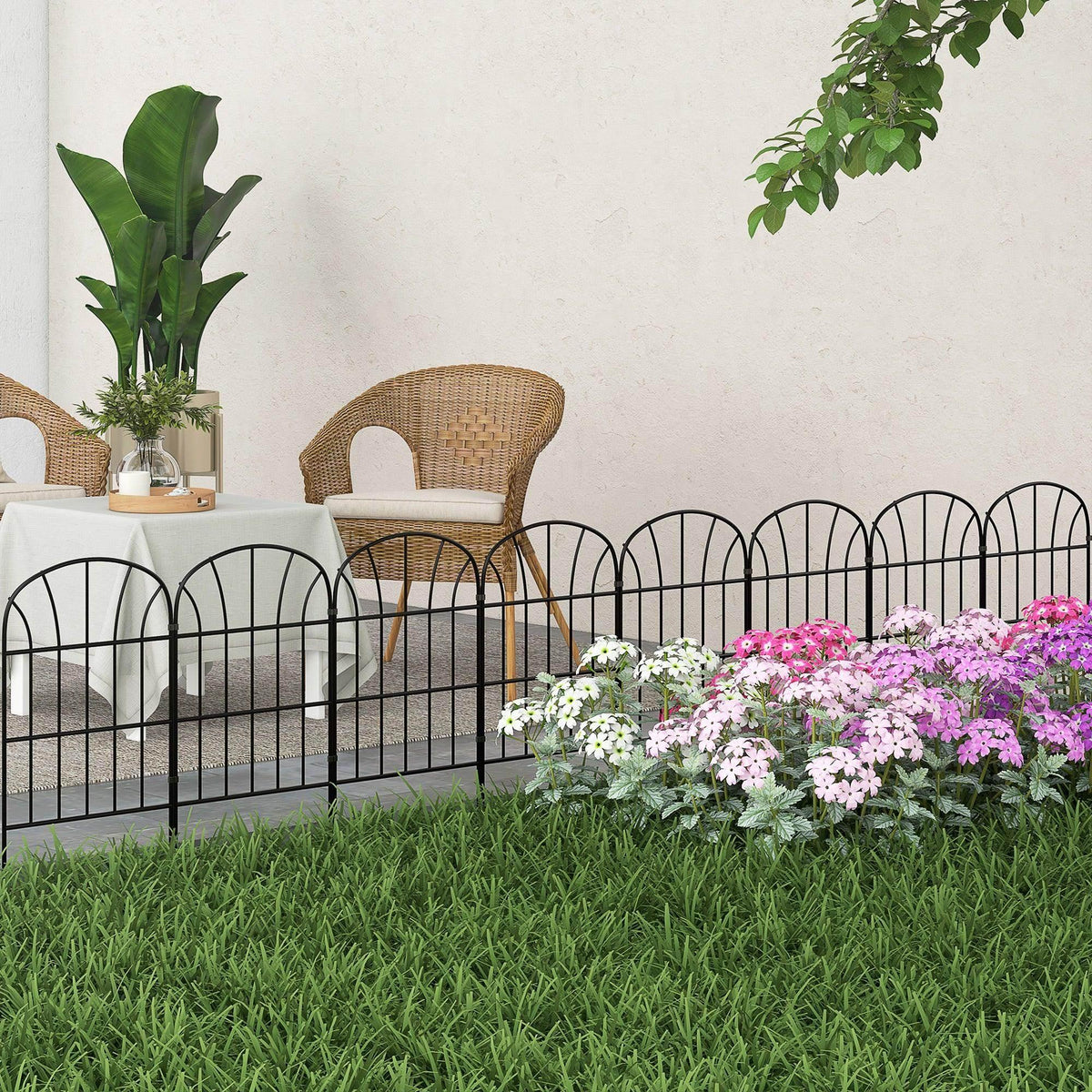 Black metal decorative picket fence panels with arched tops, yard installation