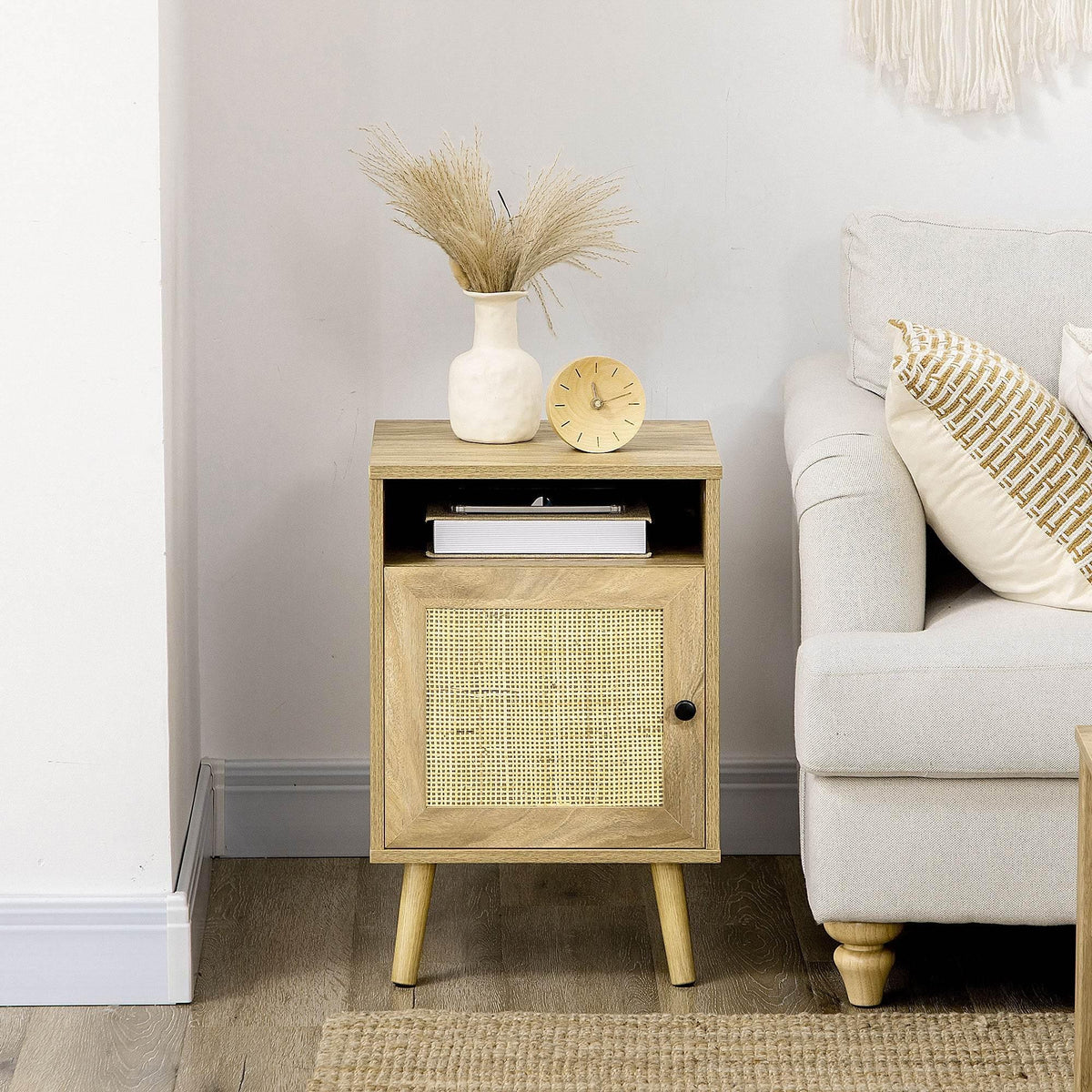 Rattan-inspired bedside table with open shelf and woven door, light wood and black knob
