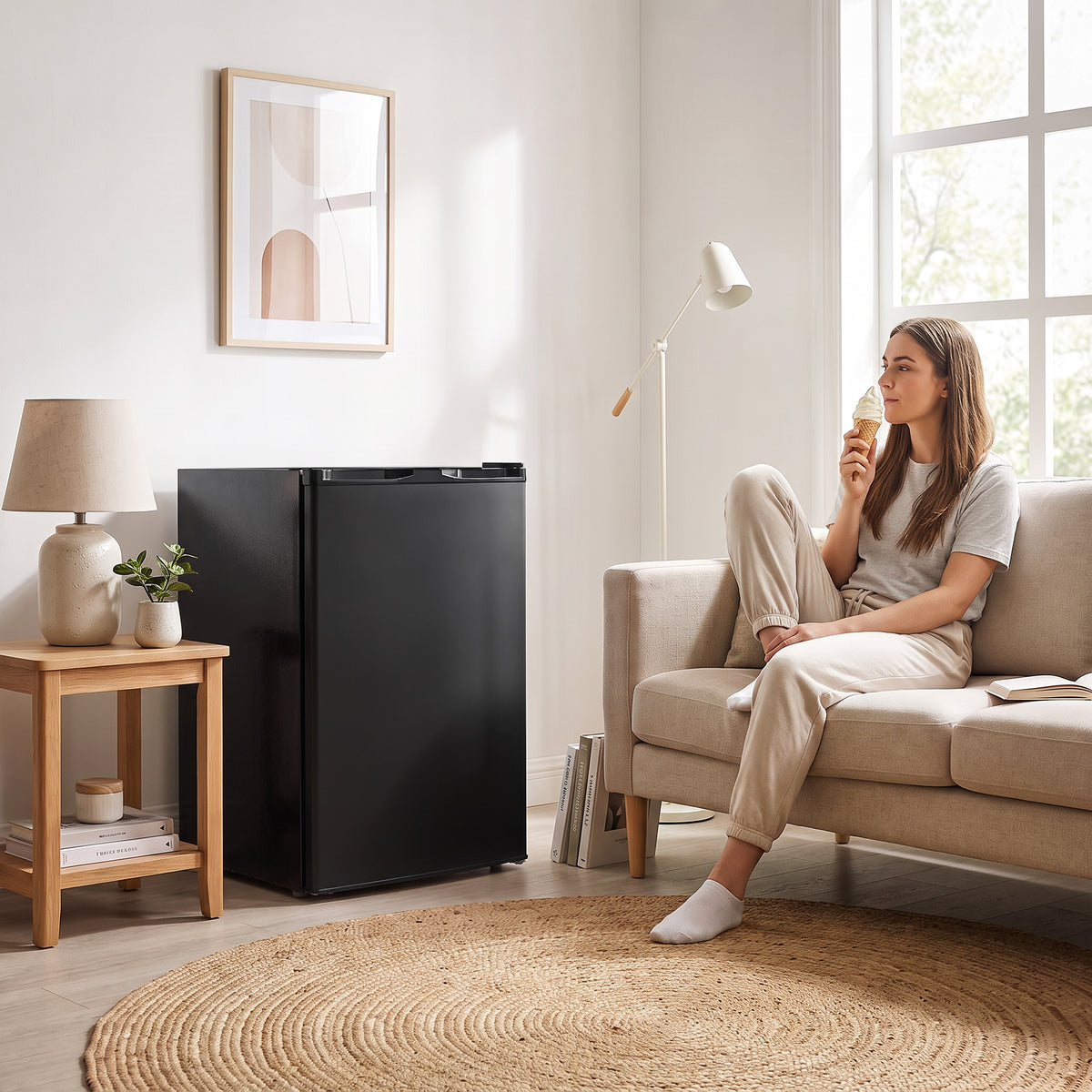 Black compact upright freezer in a living room setting