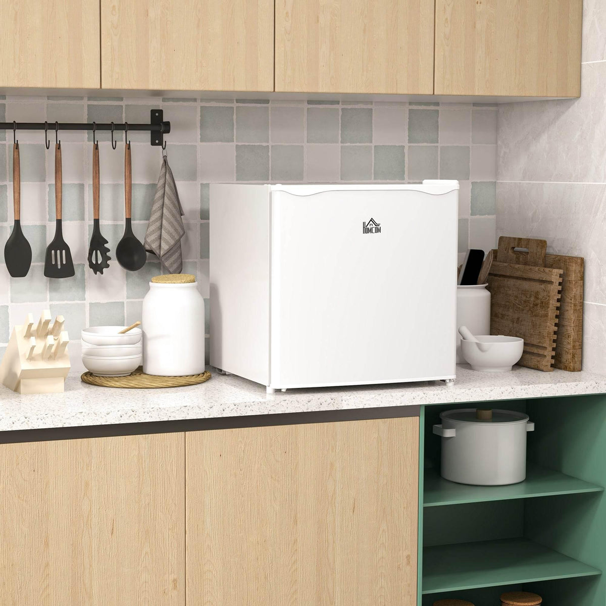White compact mini freezer with front logo and curved top lid handle, space-saving design.