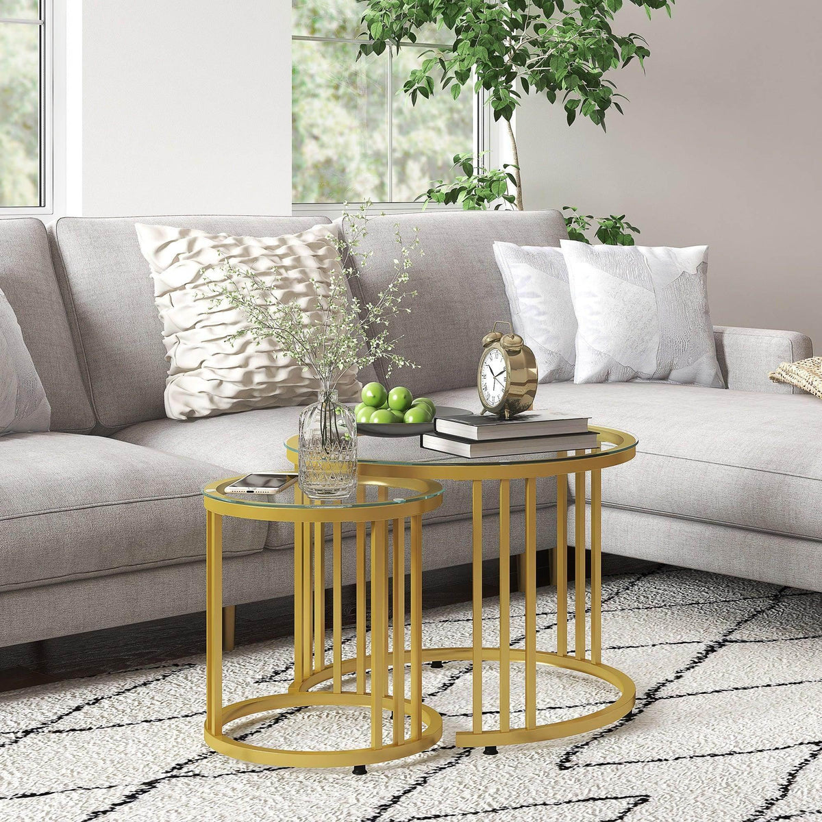 Gold round nesting coffee tables with clear tempered glass tops and open ring base